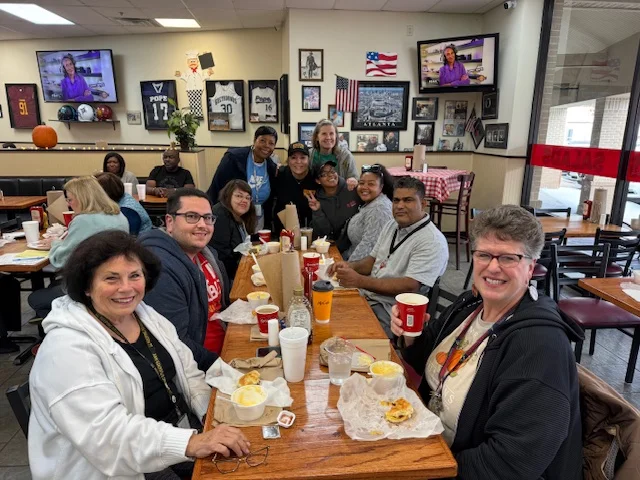 Group of friends enjoying a meal in a cozy restaurant setting