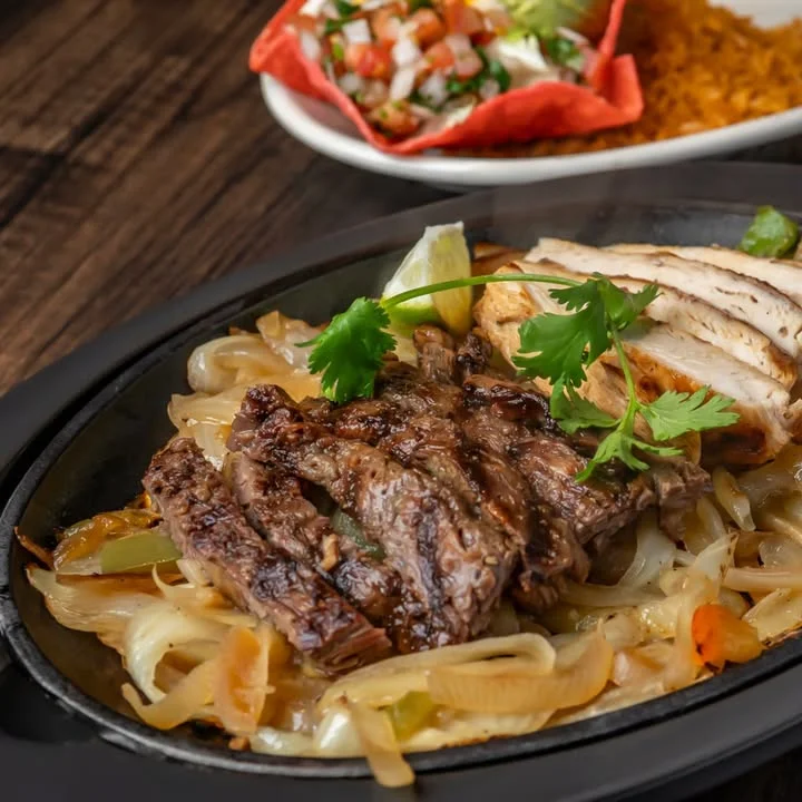 Sizzling fajitas with grilled steak and chicken