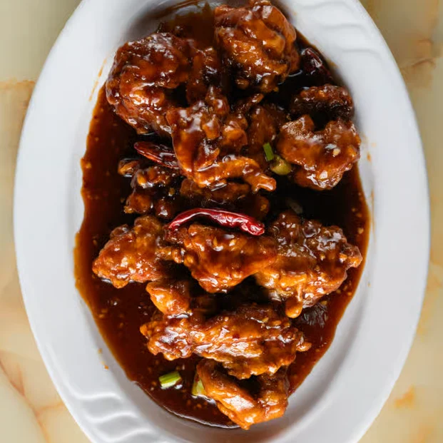 Sweet and spicy General Tso's chicken on a white plate