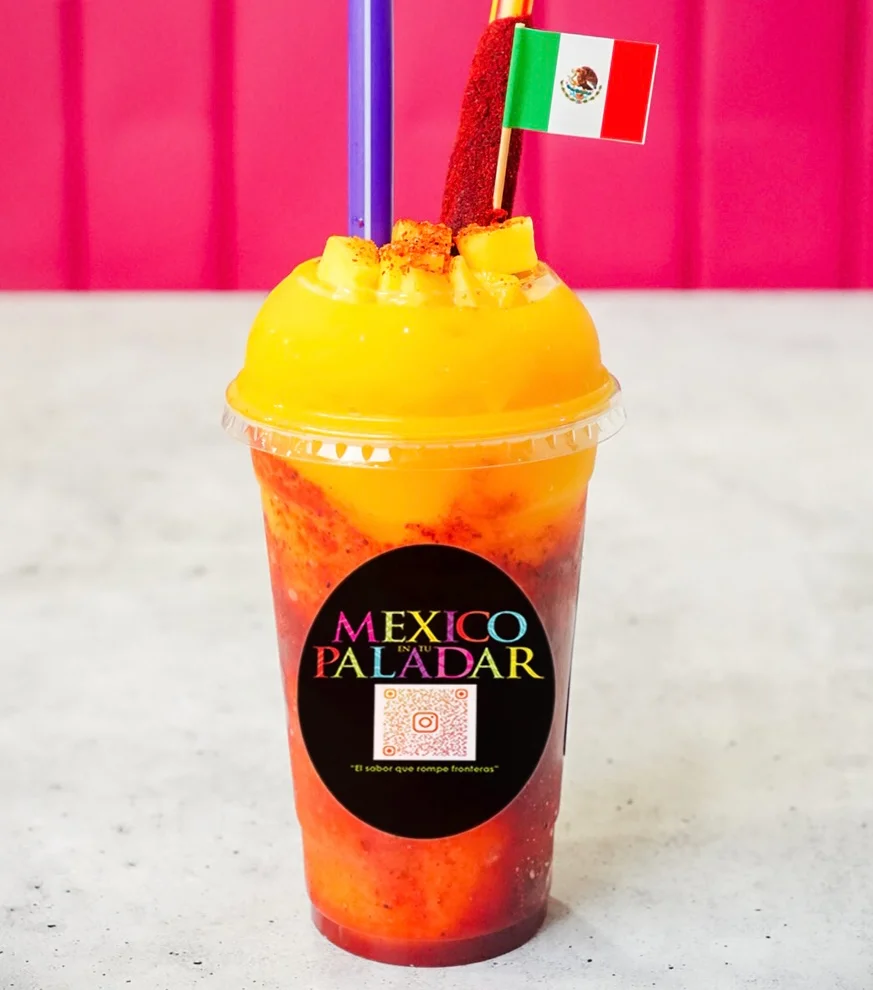 Colorful Mexican mangonada drink with tamarind and fruit toppings