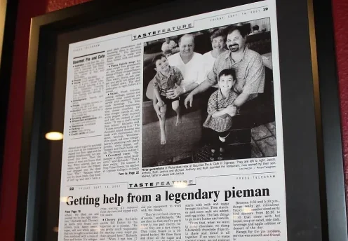 Framed newspaper feature about a legendary pie maker