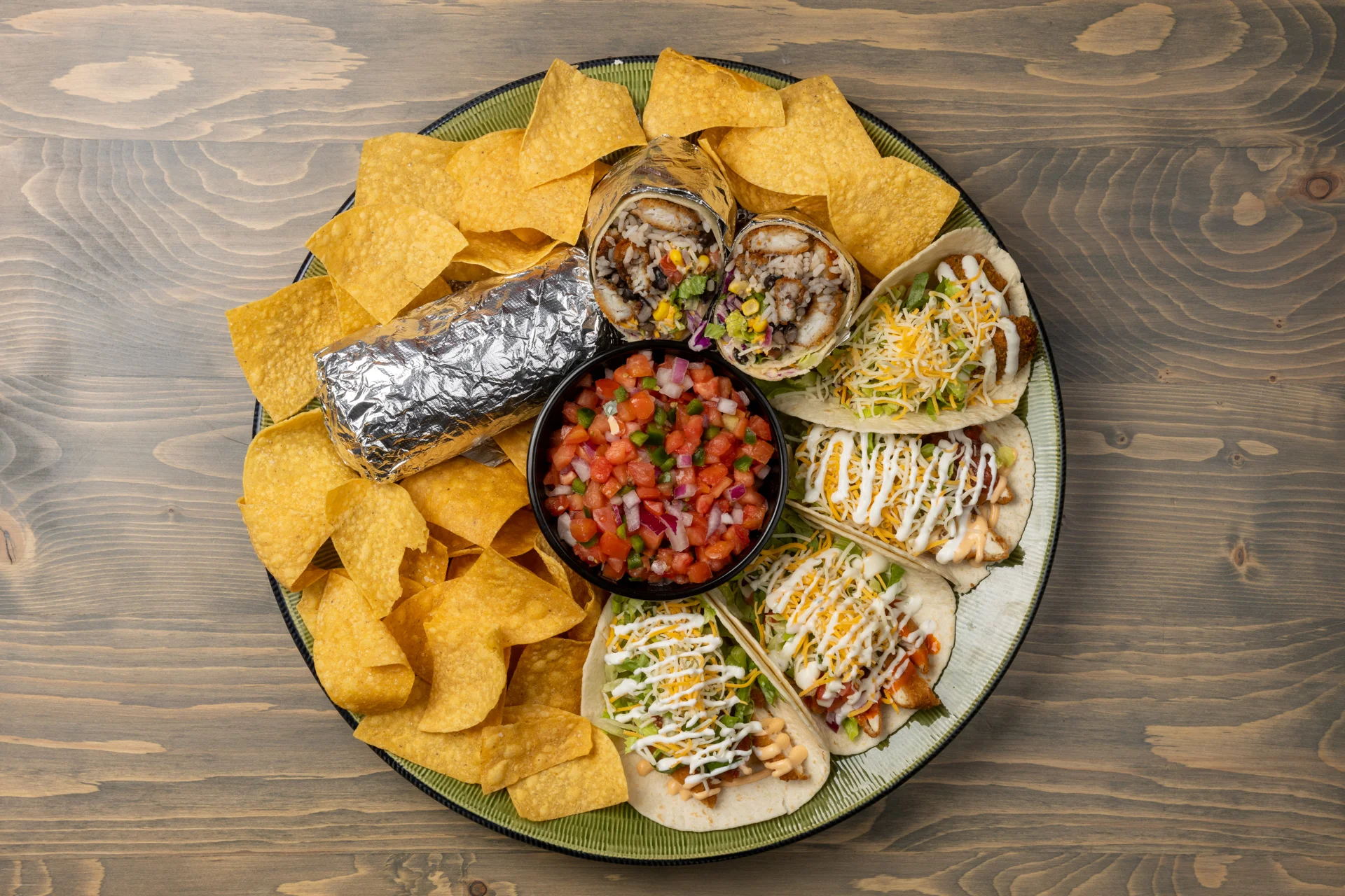 Platter of Mexican tacos with chips and salsa