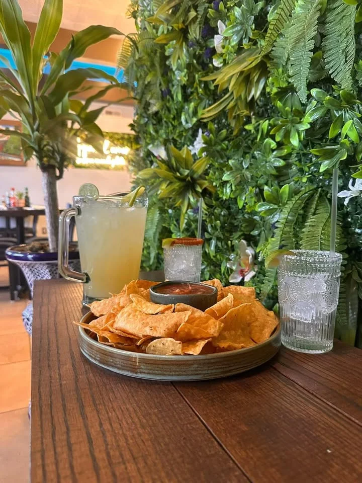 Plate of tortilla chips with salsa and refreshing margarita