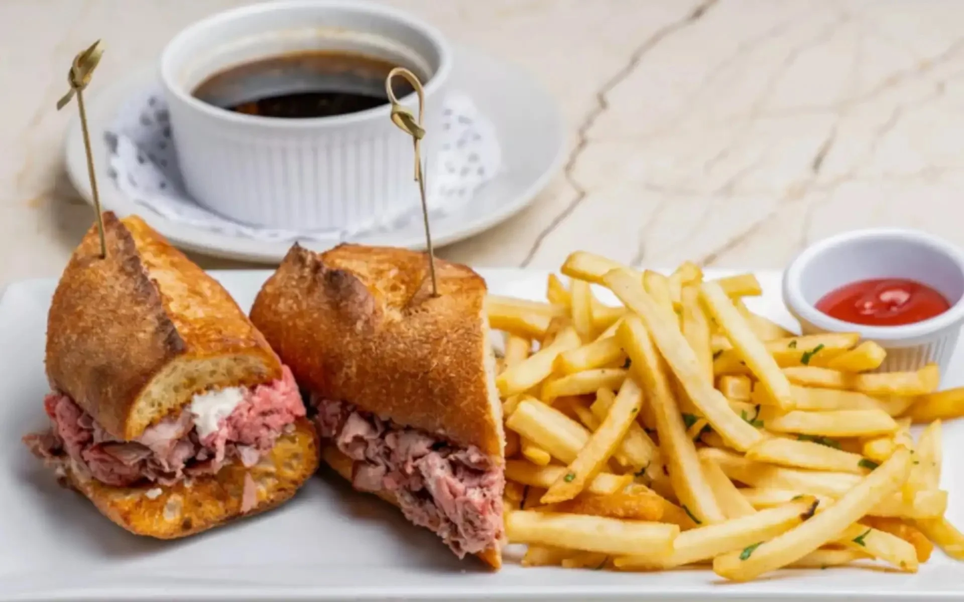 French dip sandwich with crispy fries and au jus