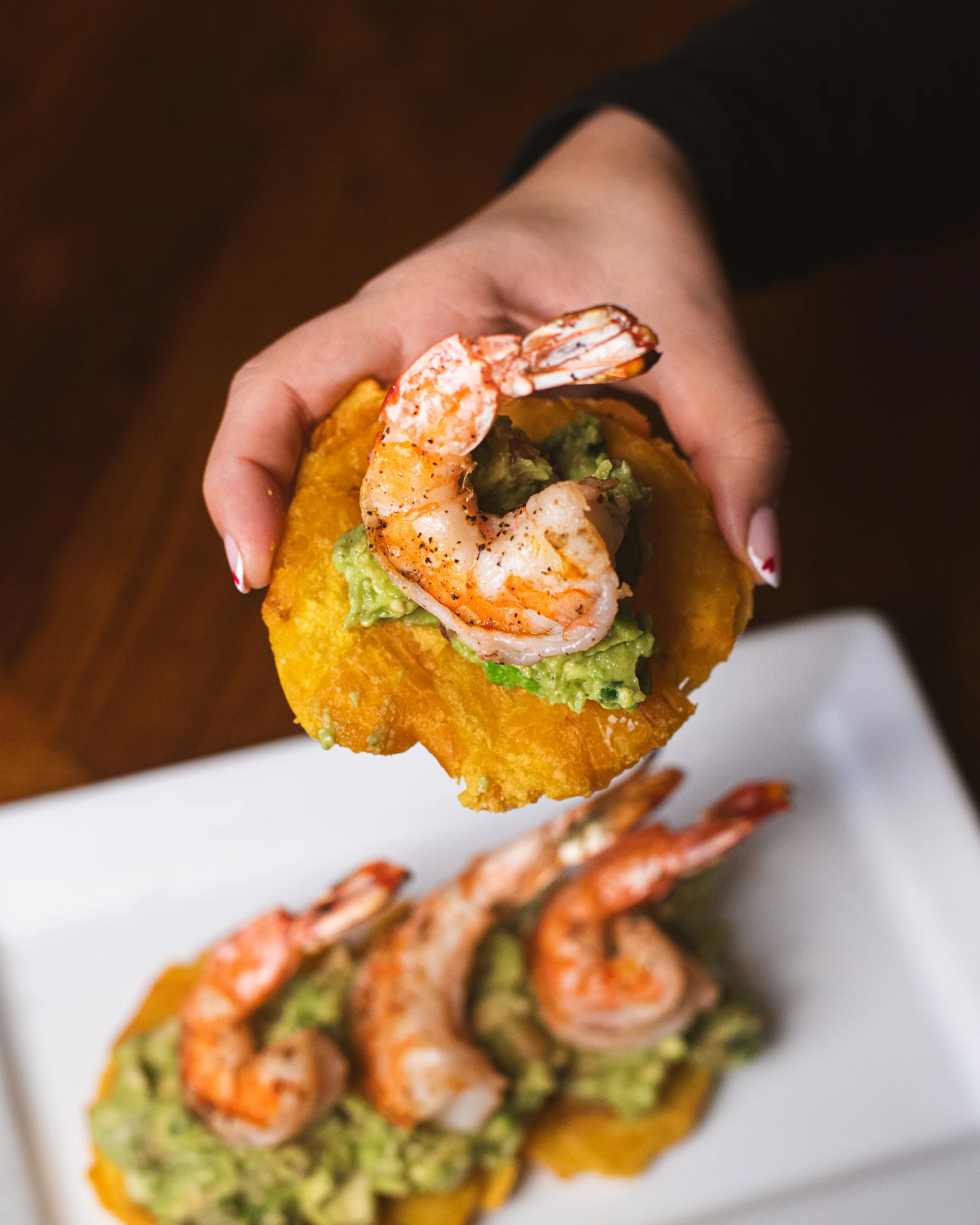 Crispy tostones topped with shrimp and guacamole