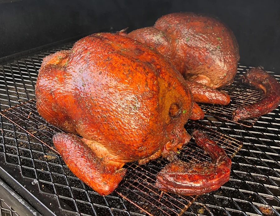 Smoked whole chickens on a barbecue grill