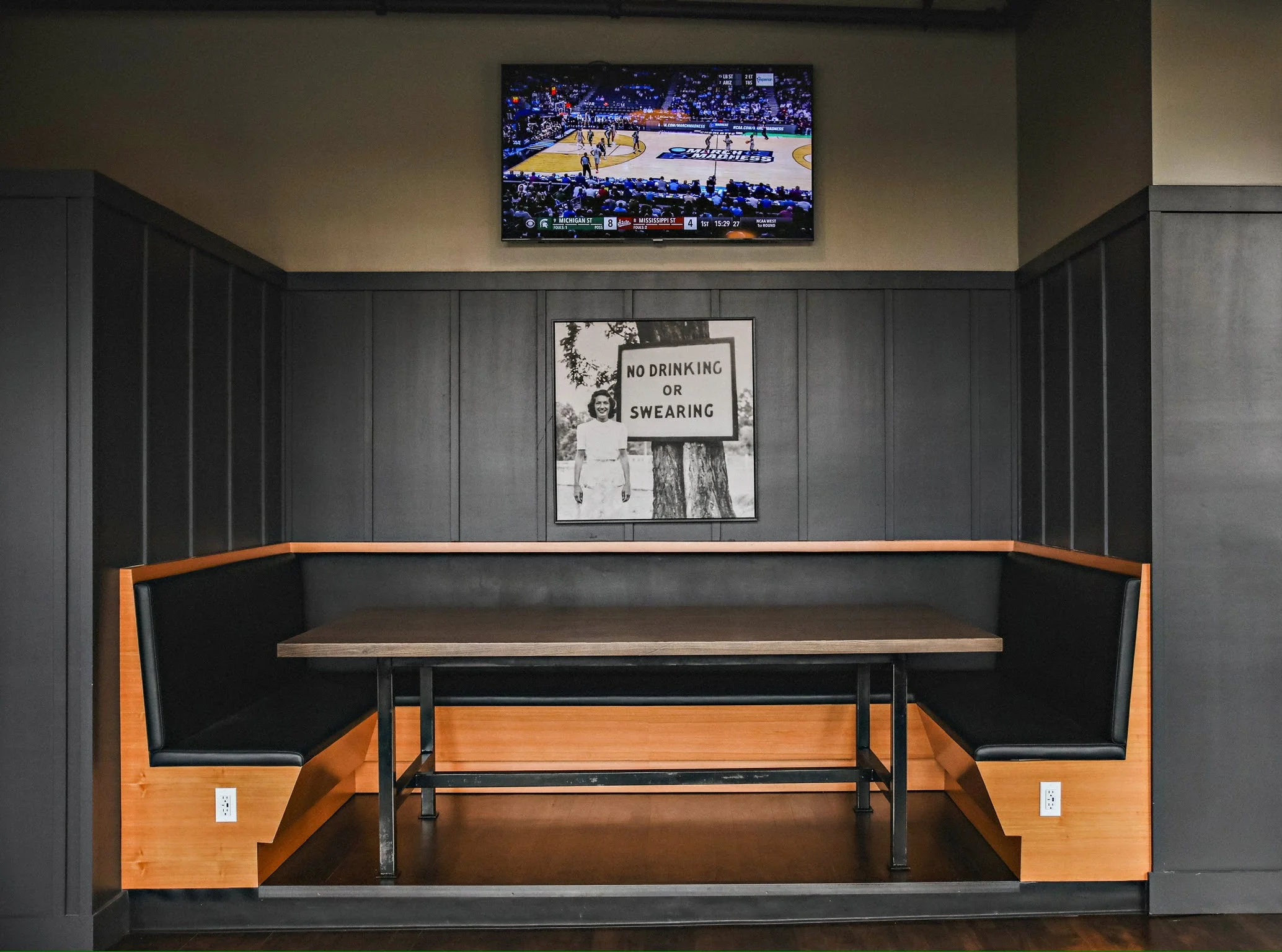 Cozy restaurant booth with vintage decor and TV