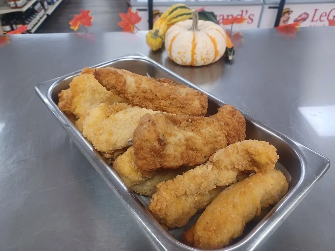 Crispy fried fish fillets served in a metal tray