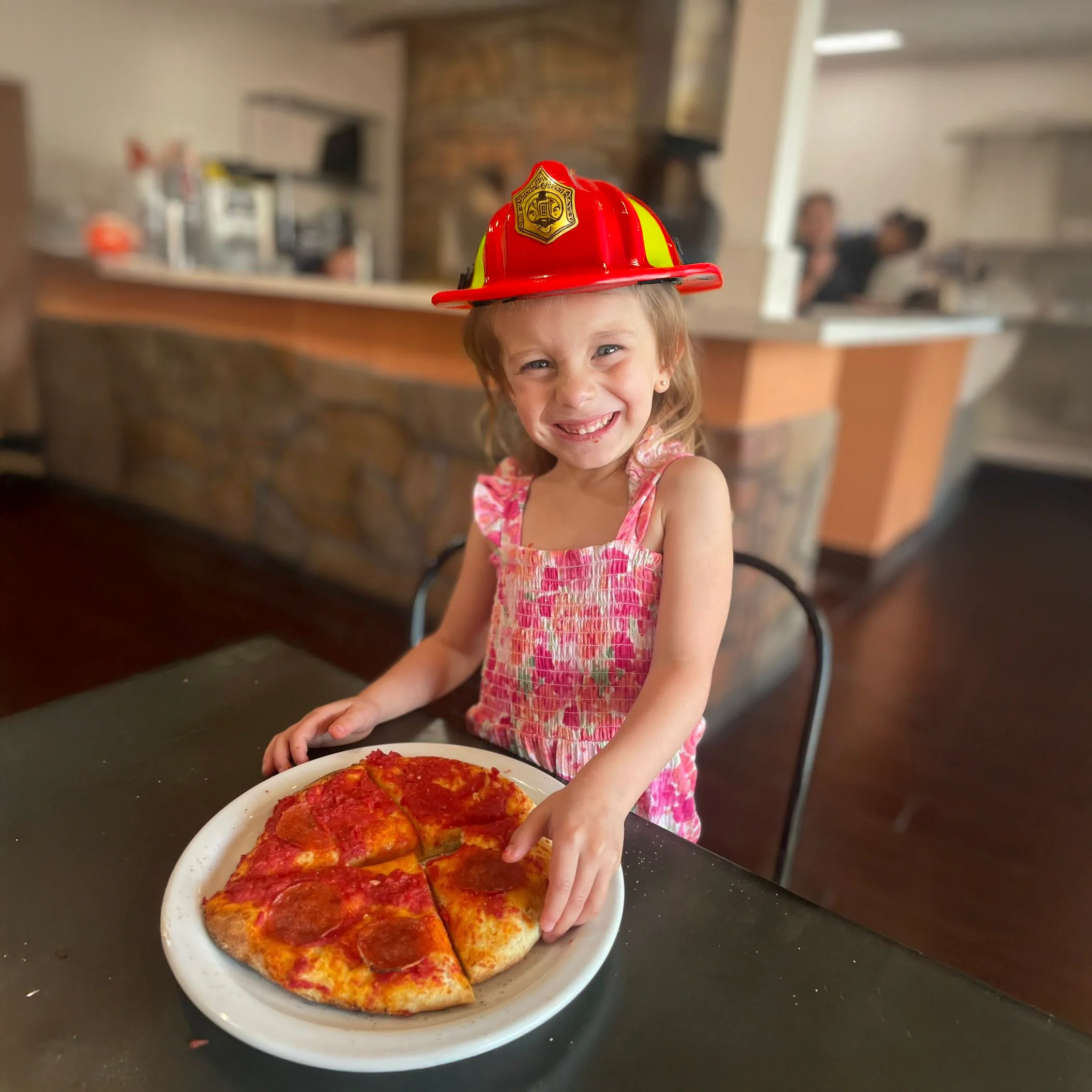 Child enjoying a pepperoni pizza in a cozy restaurant setting