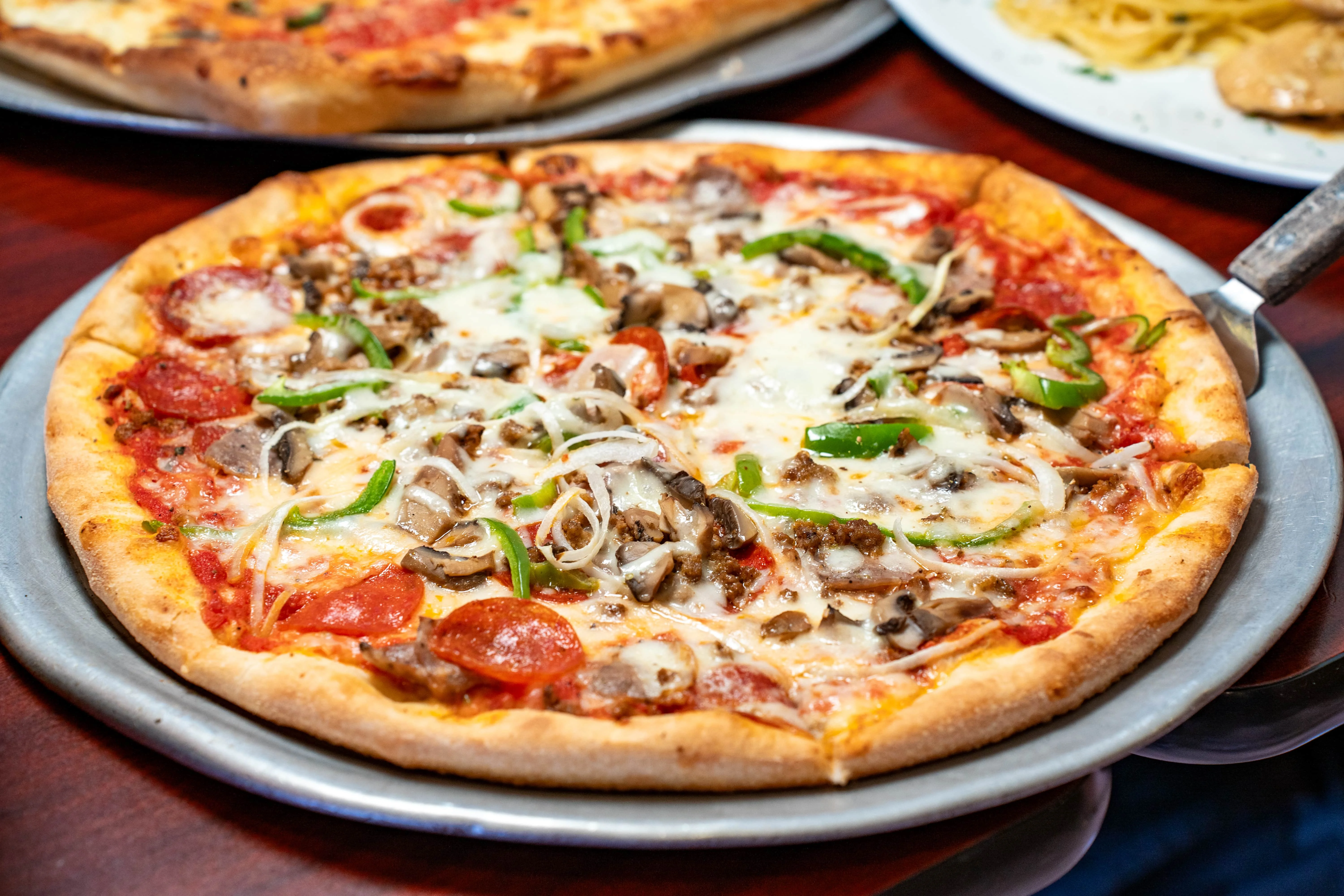 Loaded meat lover's pizza with pepperoni and vegetables