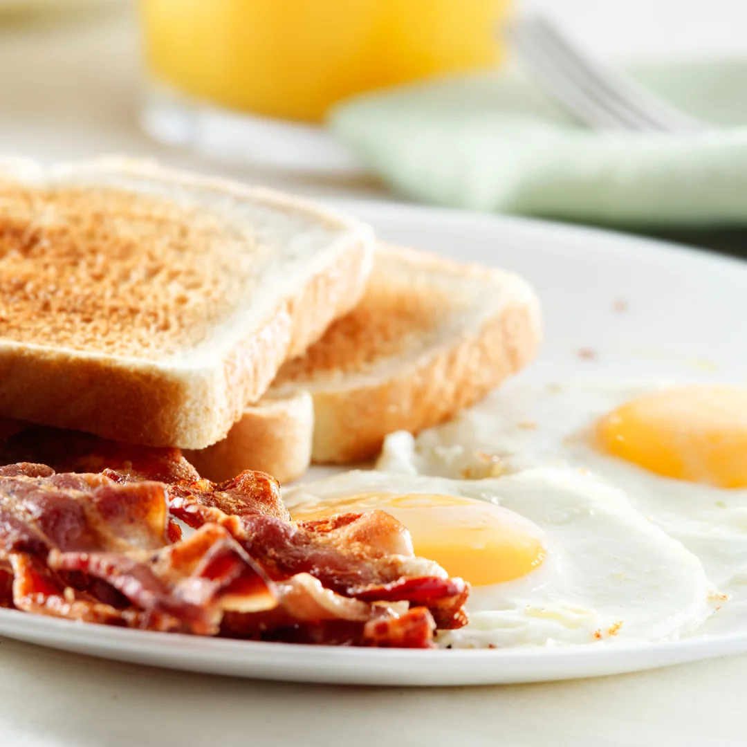 Classic American breakfast with eggs, bacon, and toast