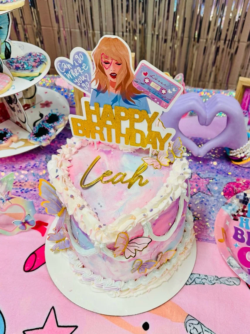 Colorful birthday cake with butterflies and festive decorations