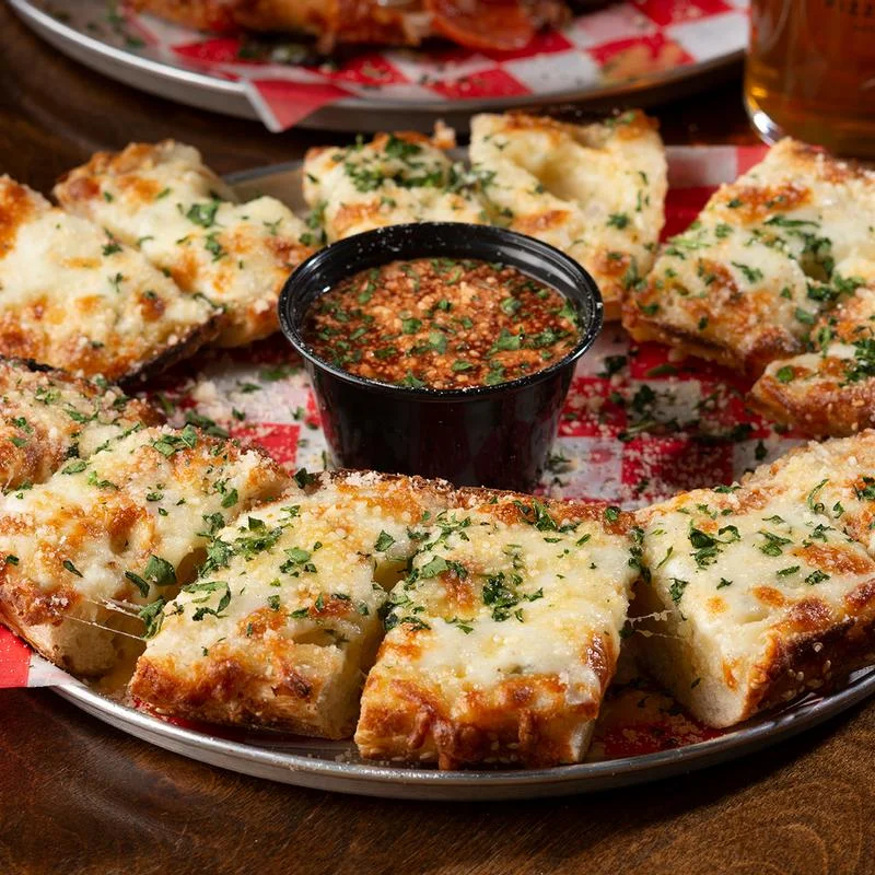 Cheesy garlic bread served with marinara sauce