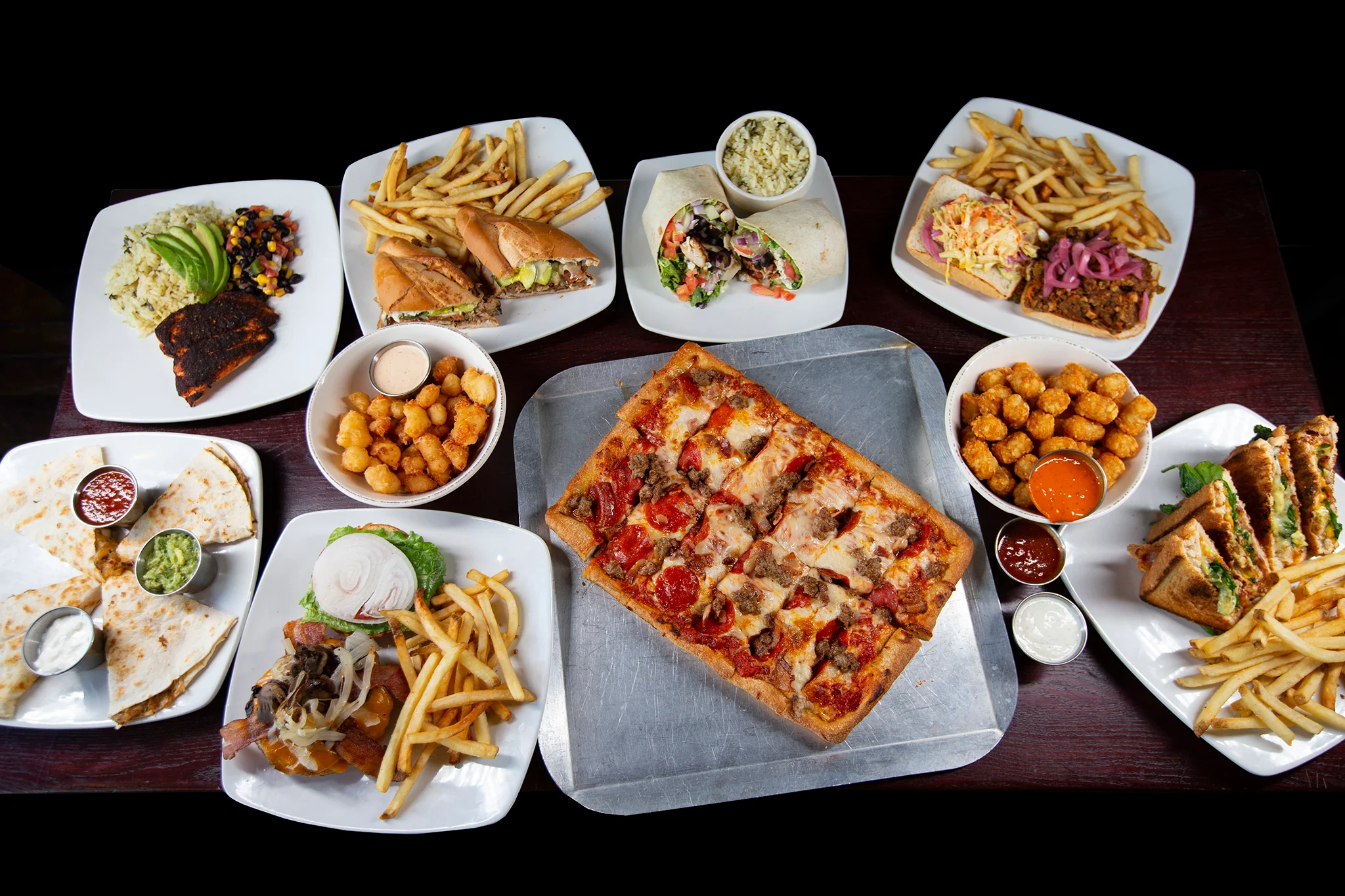 Variety of American comfort food including pizza and sandwiches