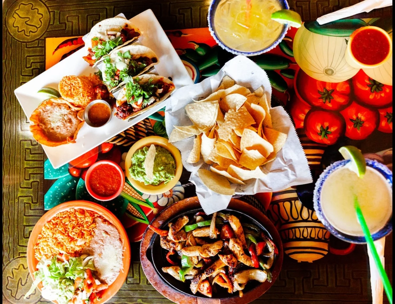 Colorful Mexican feast with tacos, fajitas, and guacamole