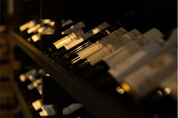 Wine bottles neatly arranged on a wooden rack