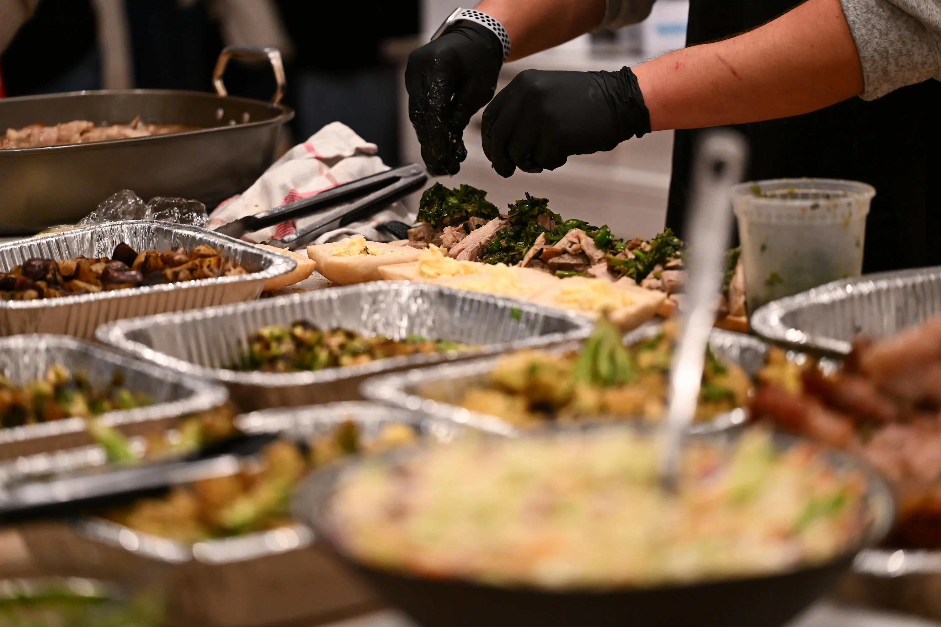 Picture of chef plating food with gloves on.