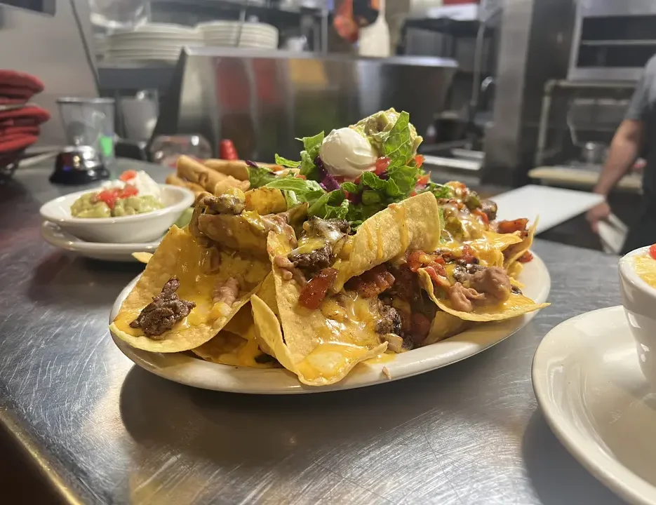 Loaded nachos topped with cheese and fresh toppings