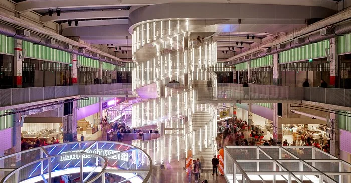 Modern restaurant interior with spiral staircase and vibrant dining areas