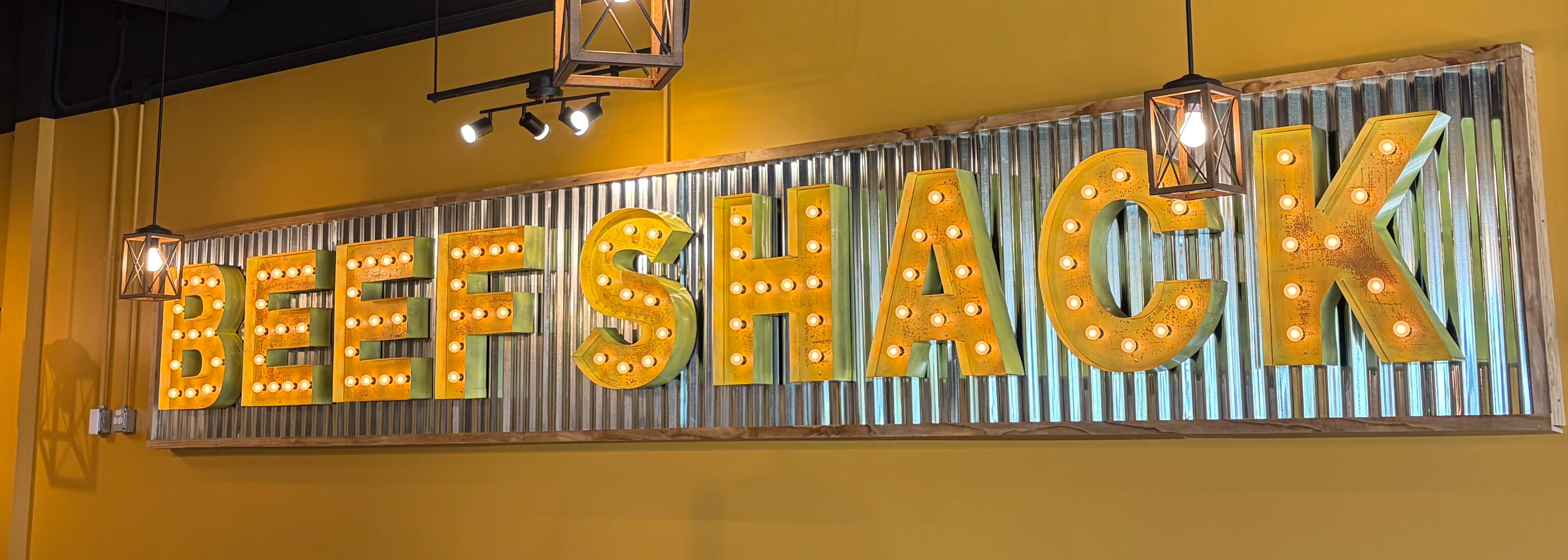Cozy restaurant interior with illuminated signage and warm colors
