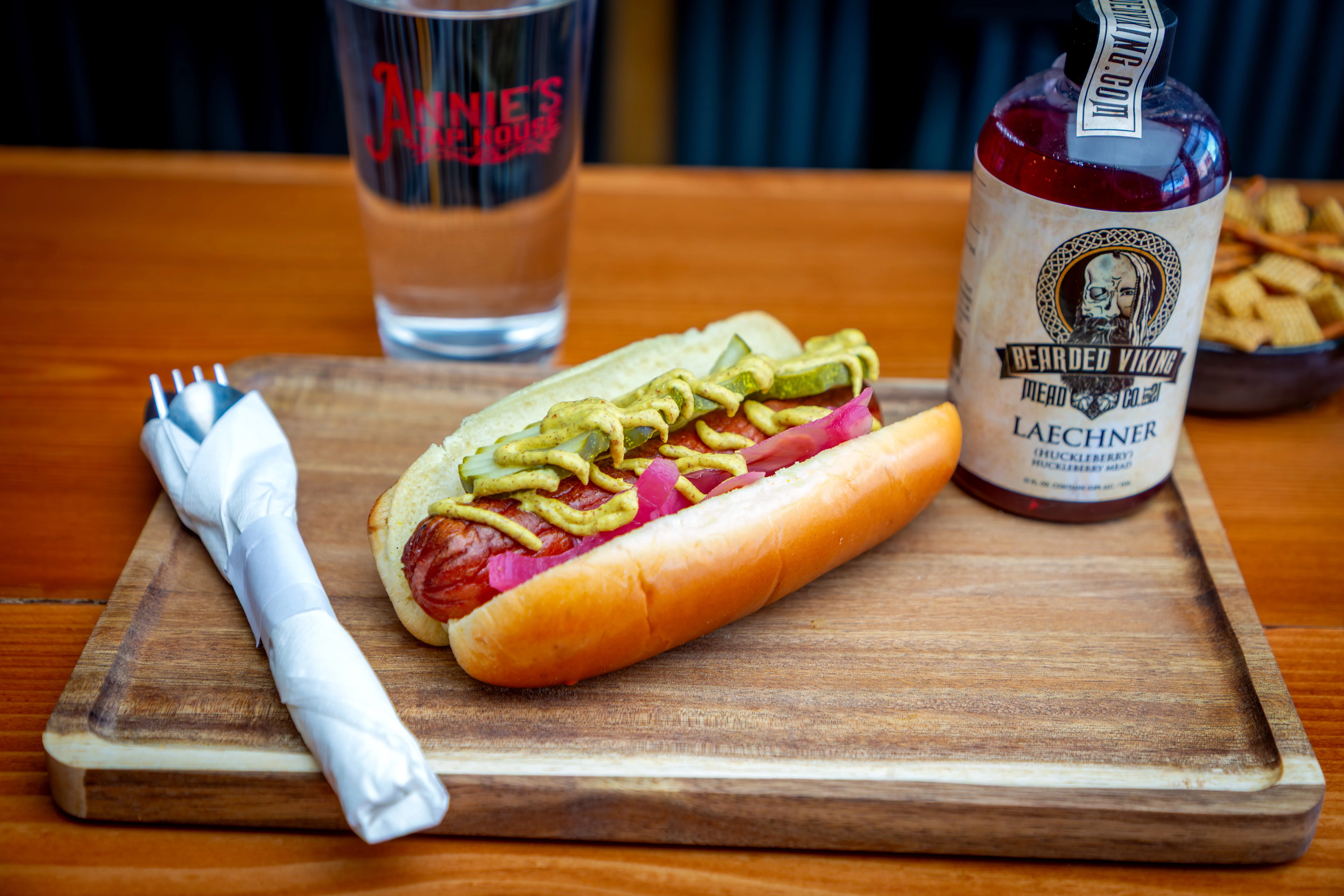 Classic American hot dog with mustard and pickles