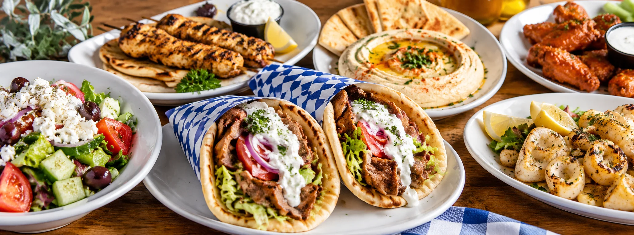 Mediterranean platter featuring gyros, hummus, and grilled chicken skewers
