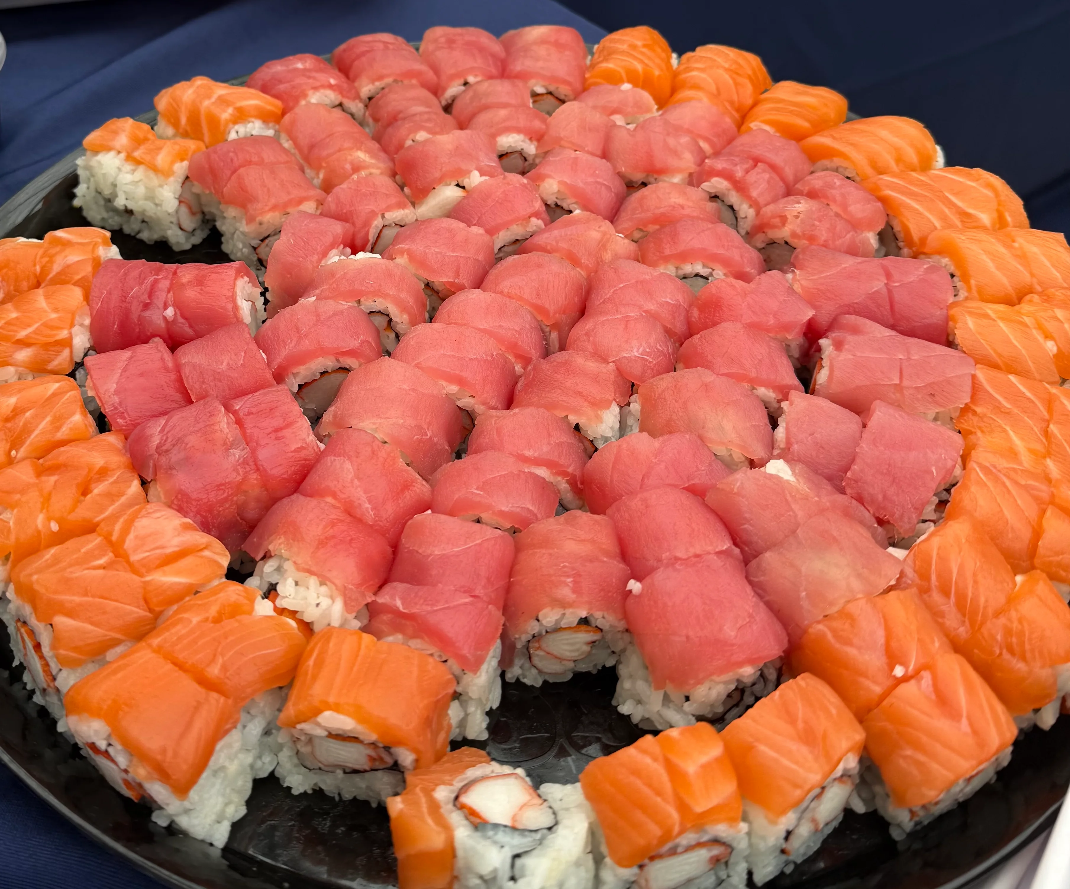 Japanese sushi rolls with cucumber and eel sauce on a decorative tray