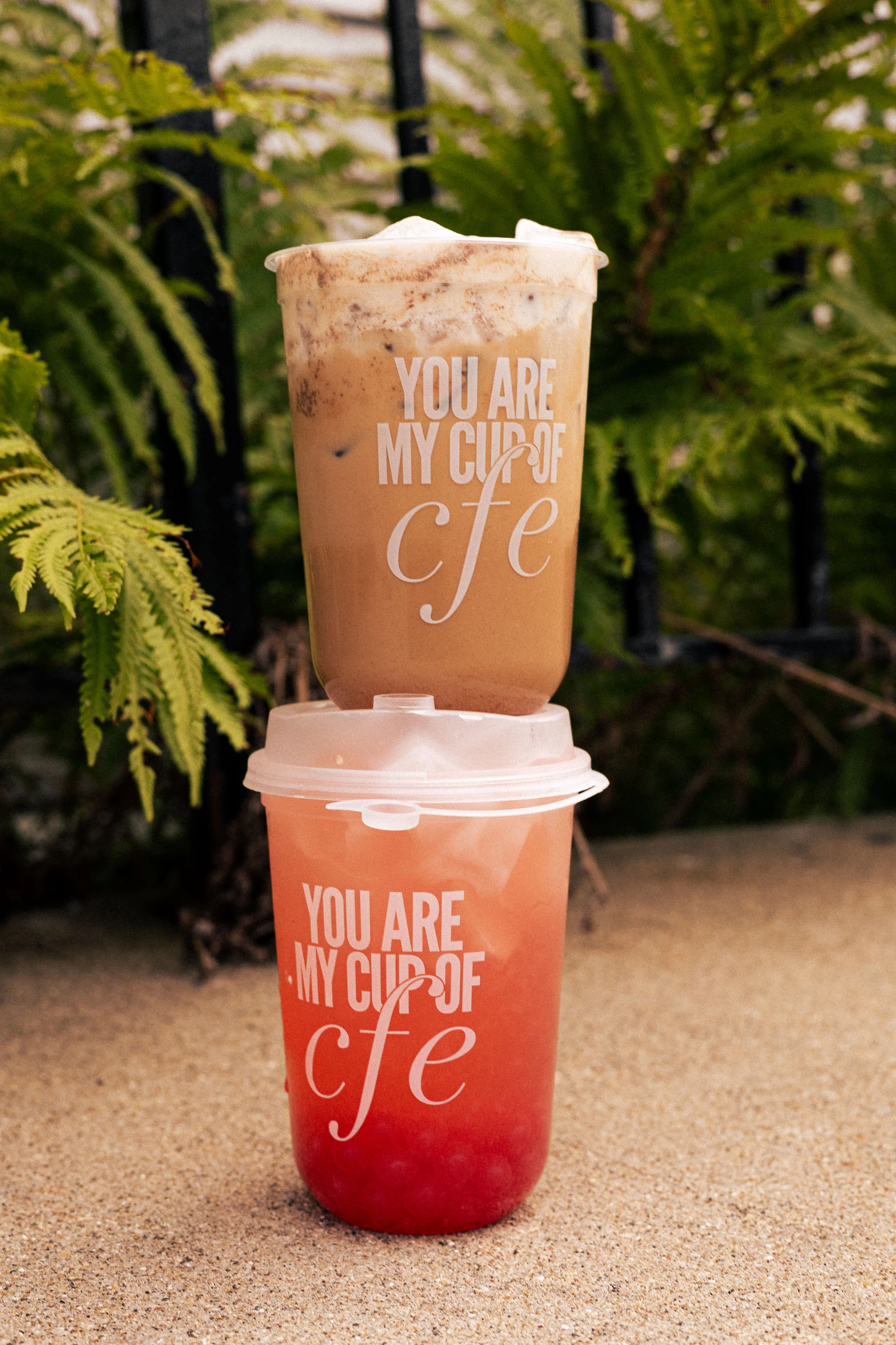 Barista pouring espresso over iced milk for a coffee drink