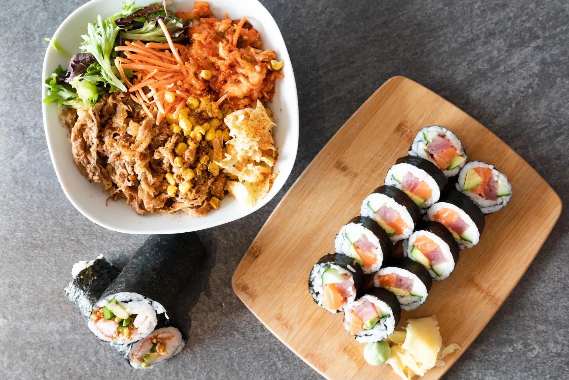 Japanese sushi rolls with a colorful fusion rice bowl