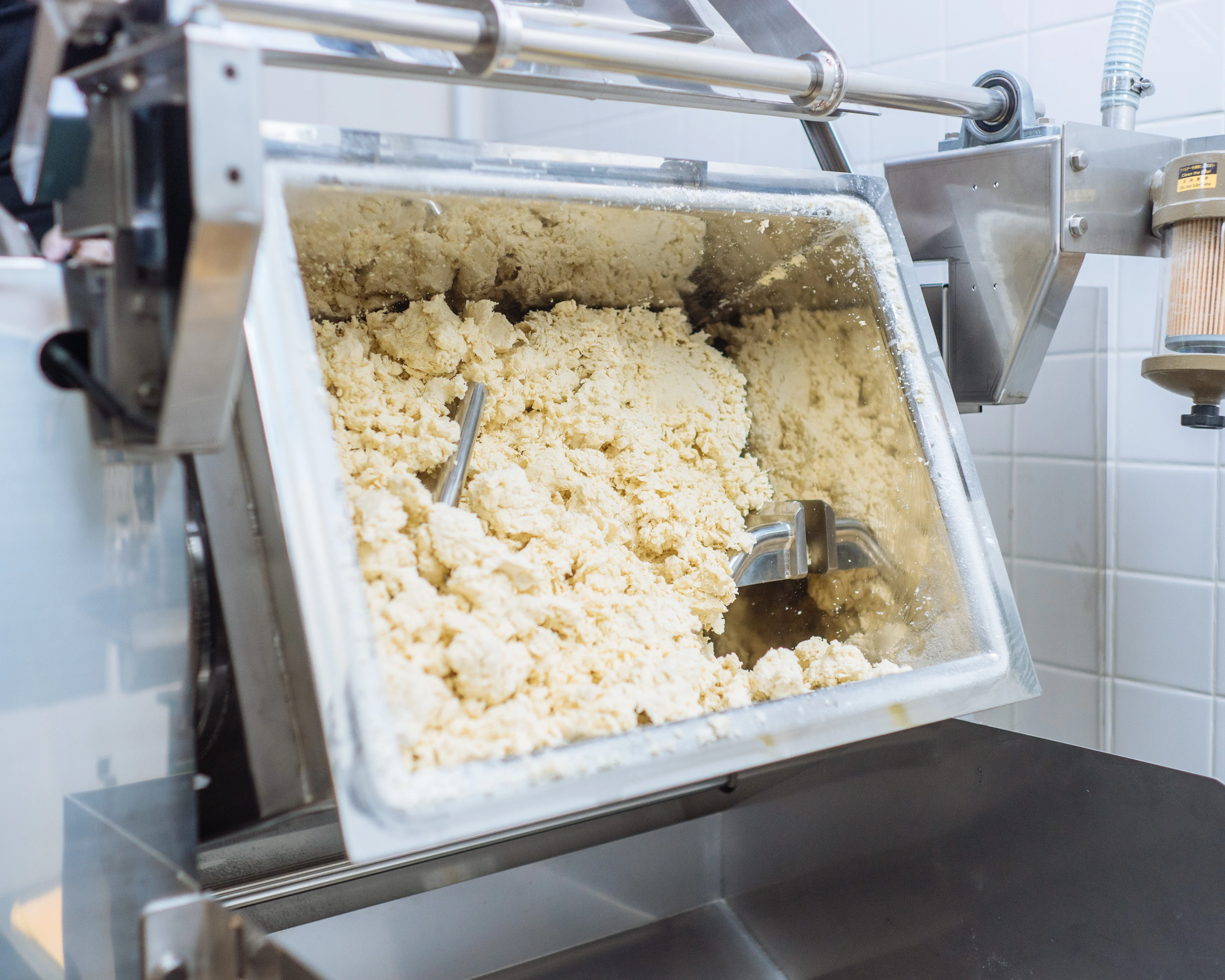Fresh noodle dough being mixed in Goma Tei's noodle-making equipment.