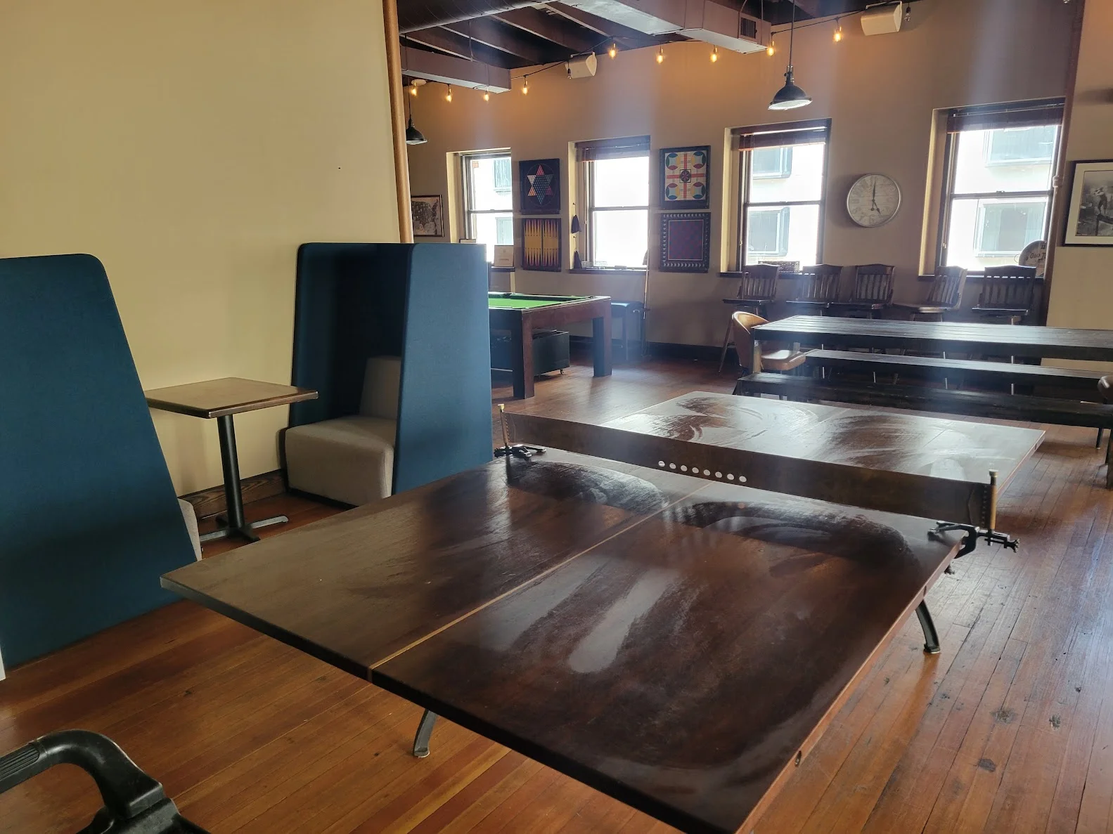 Spacious restaurant interior with wooden tables and cozy seating