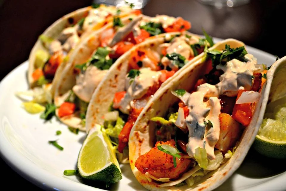 Delicious shrimp tacos with creamy sauce and fresh toppings