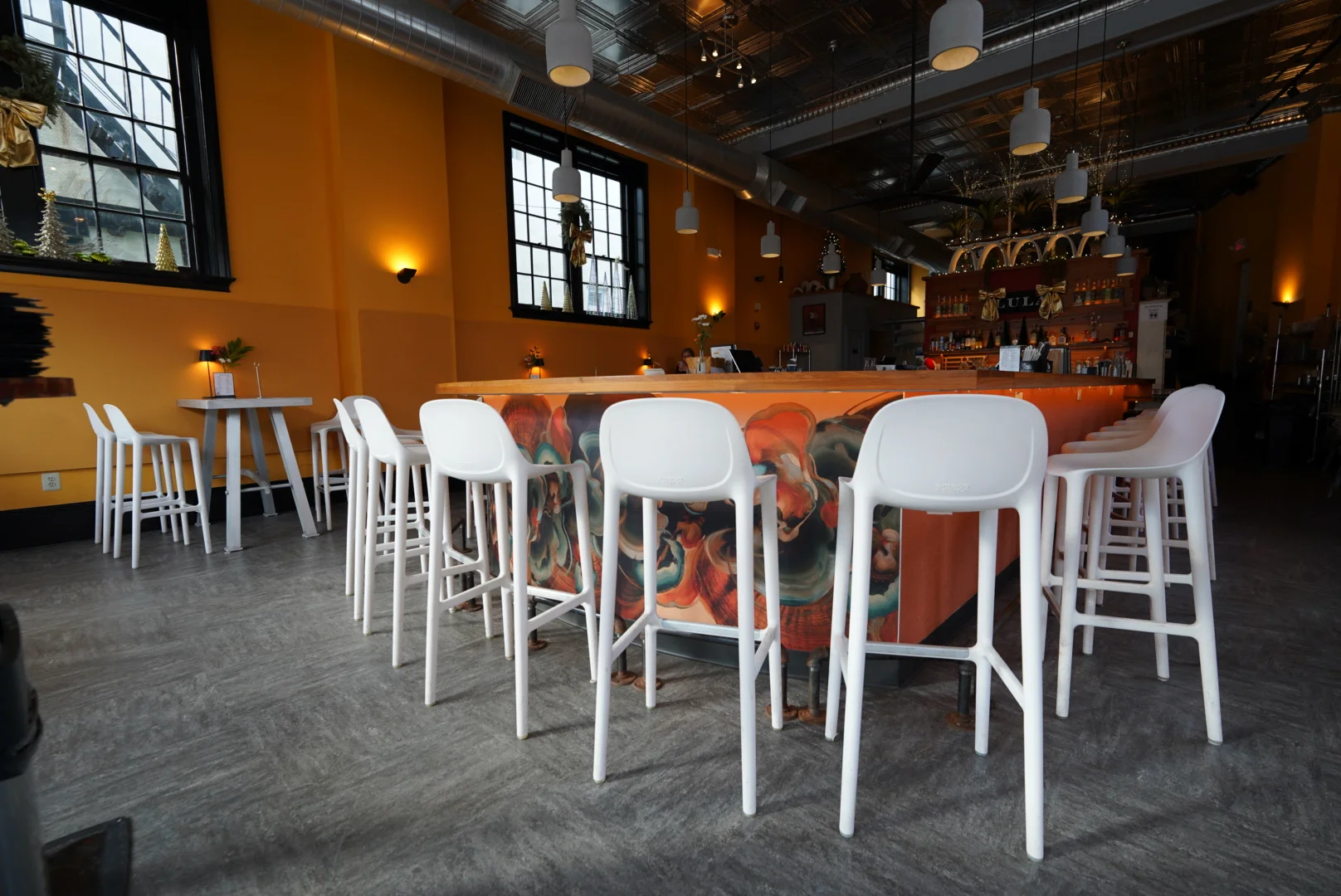 Modern restaurant interior with vibrant colors and bar seating