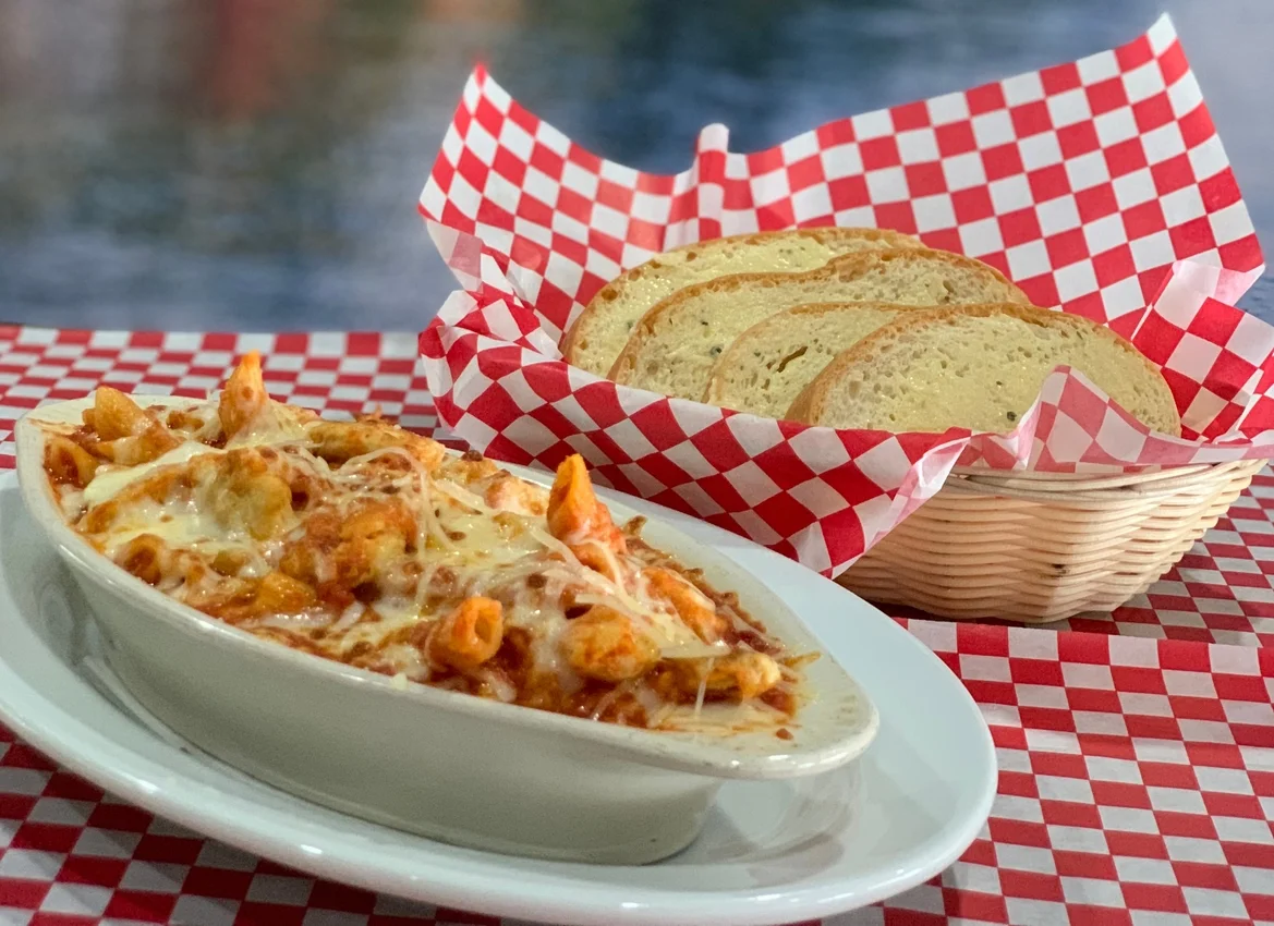 Baked ziti with melted cheese in a cozy restaurant setting