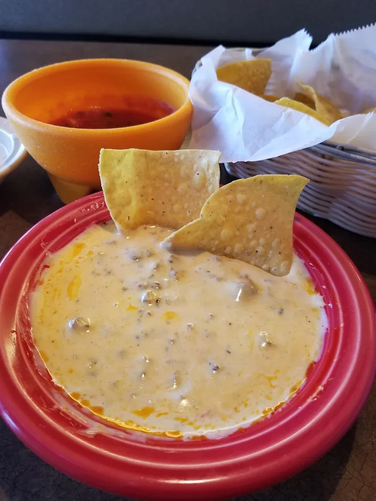 Creamy queso dip with tortilla chips in a Mexican restaurant