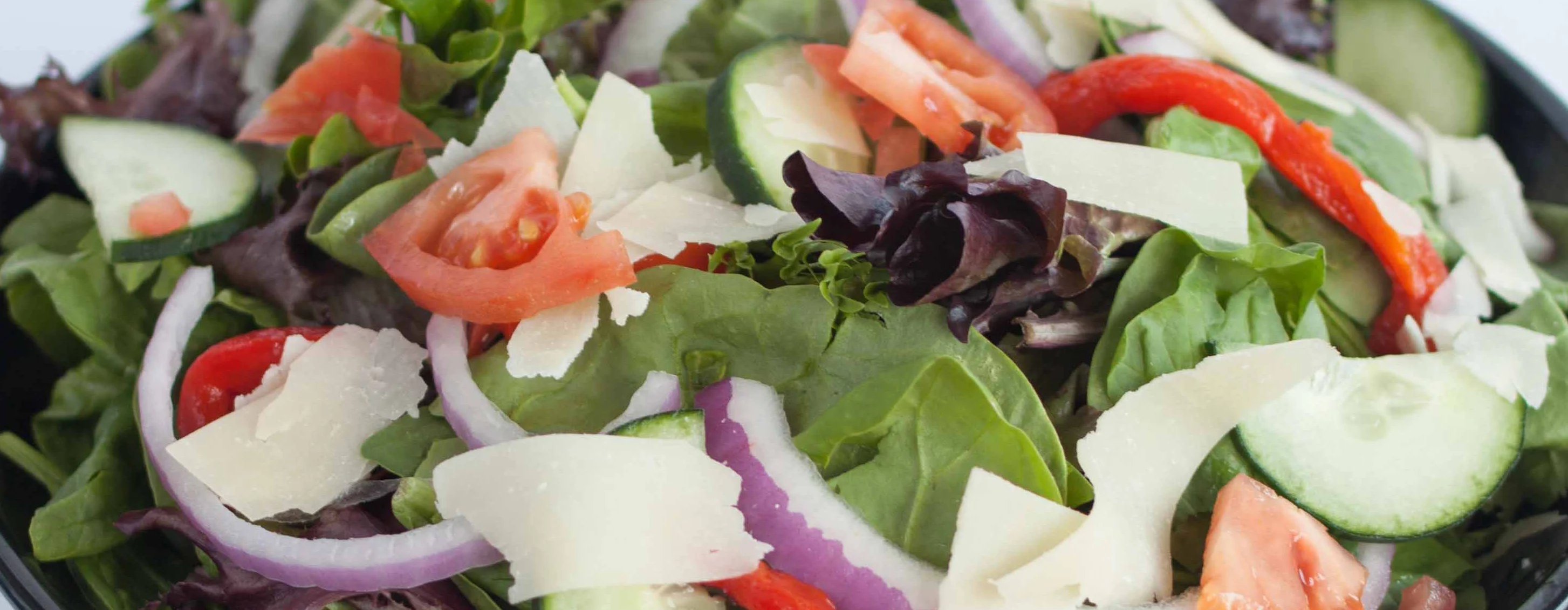 Fresh garden salad in a black bowl