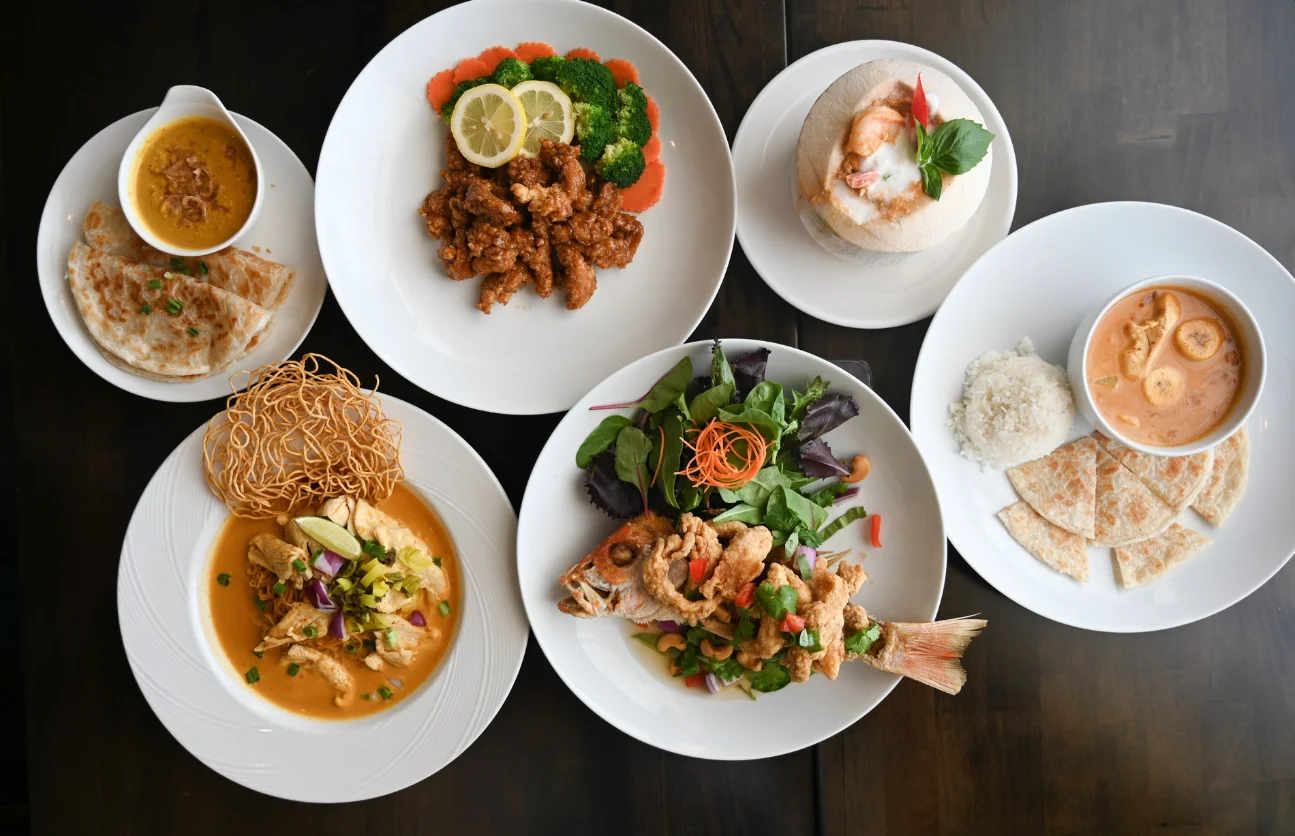 Assorted Asian dishes including fried fish and curry