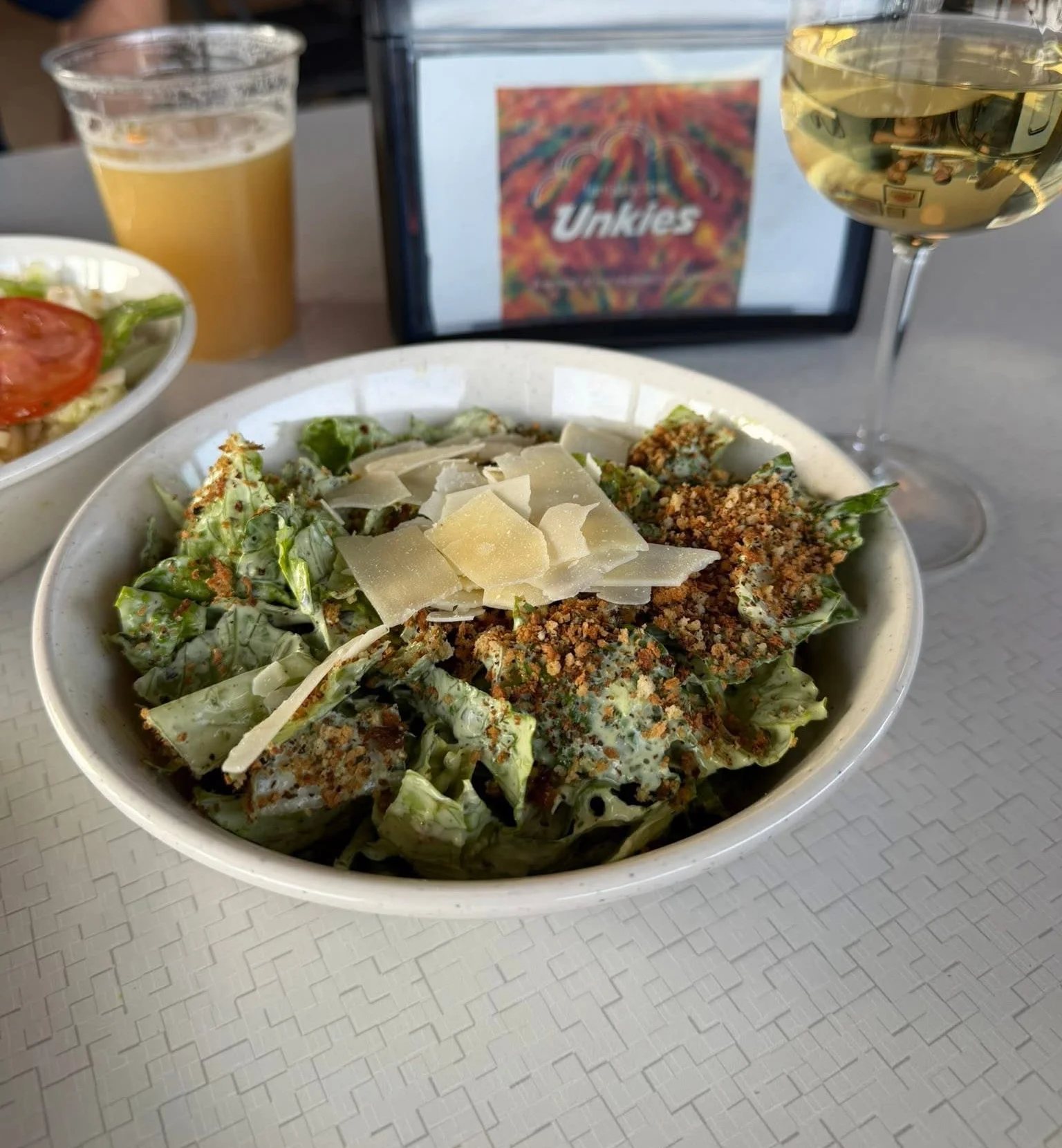 Caesar salad with parmesan and croutons in a cozy restaurant setting