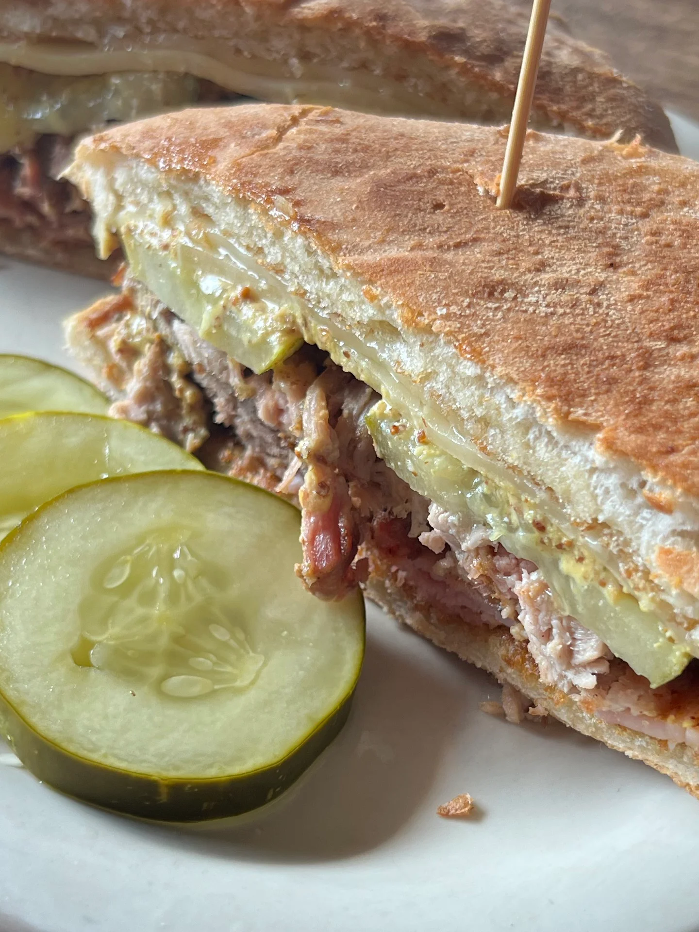 Cuban sandwich with pickles on a plate