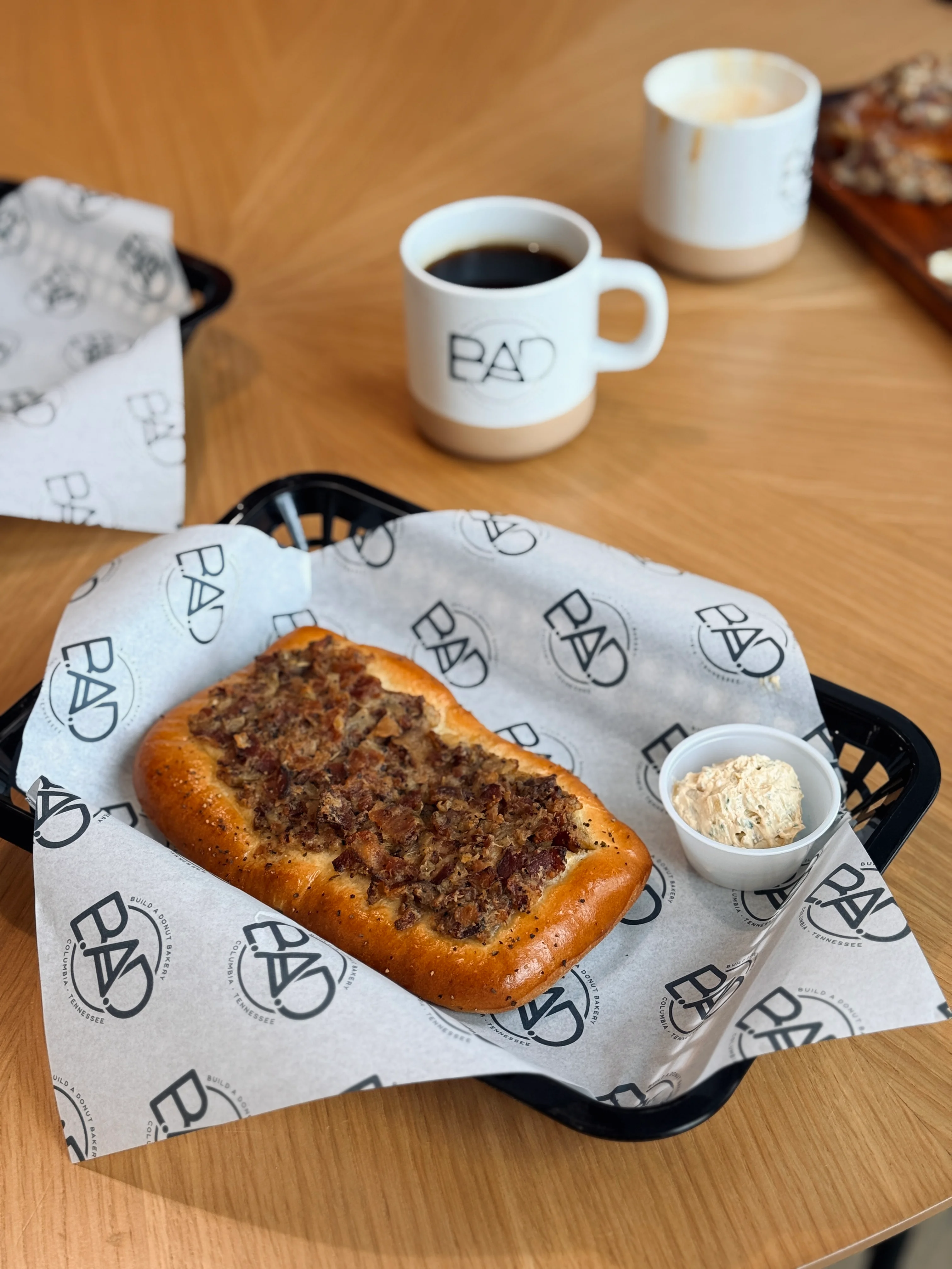 Savory meat pie served with a side of creamy dip