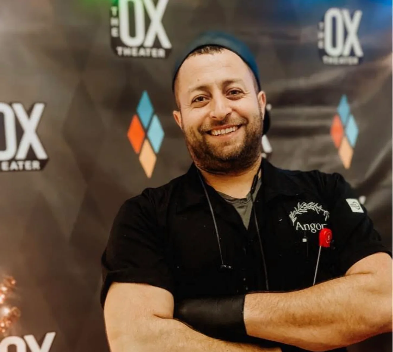 Chef smiling in front of a theater backdrop