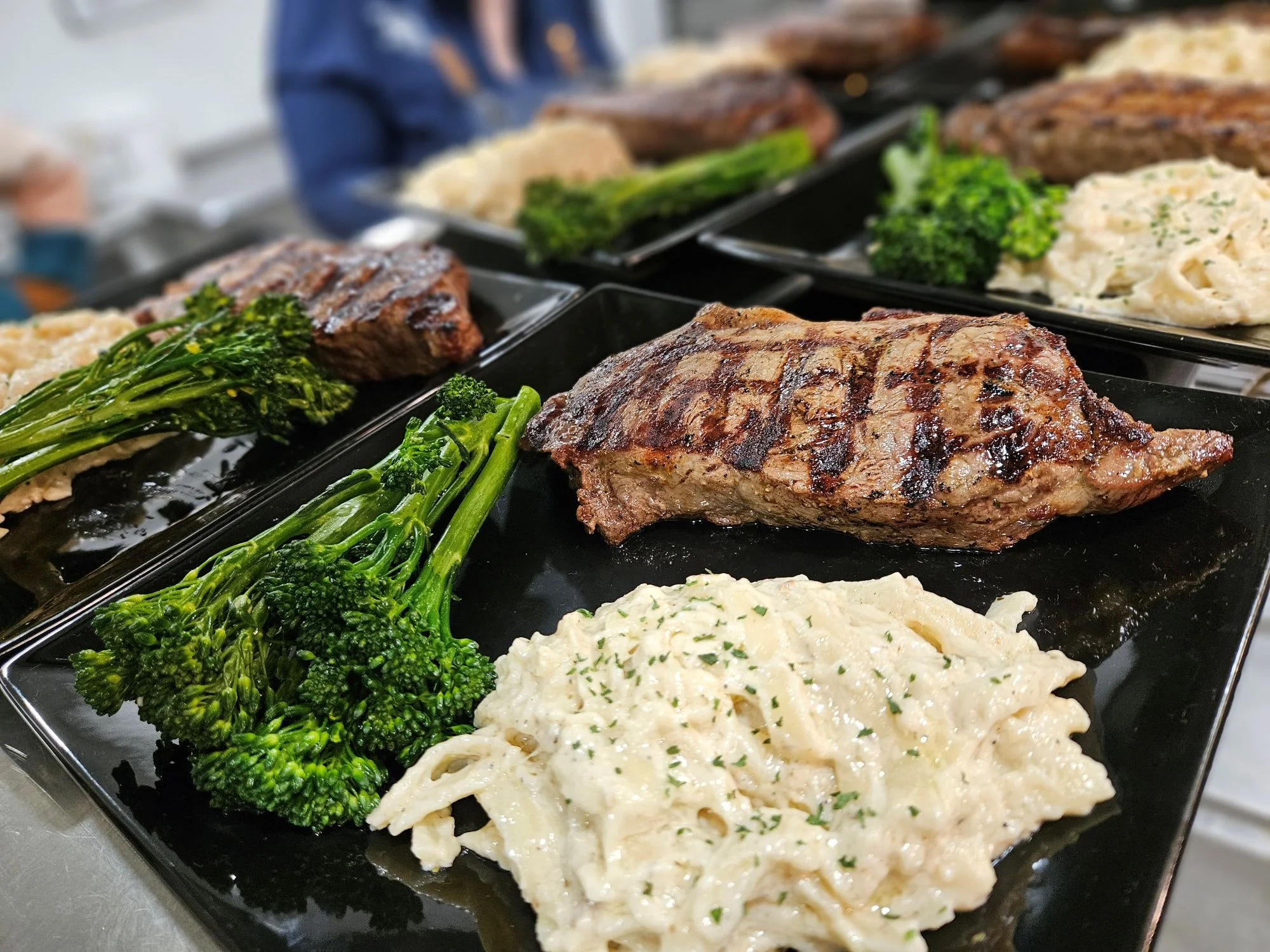 Grilled steak with creamy fettuccine and broccolini