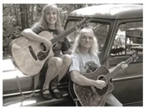 Musicians playing acoustic guitars outdoors