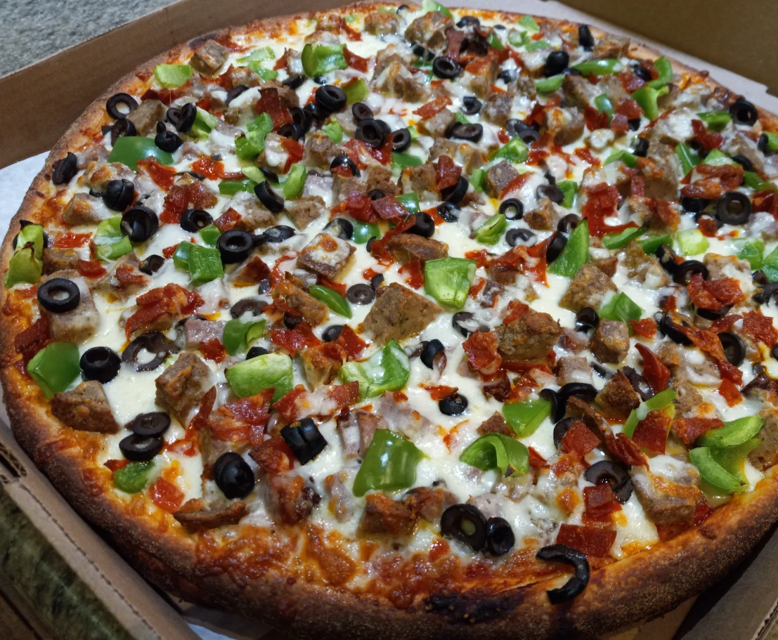 Loaded meat lover's pizza with pepperoni and green peppers