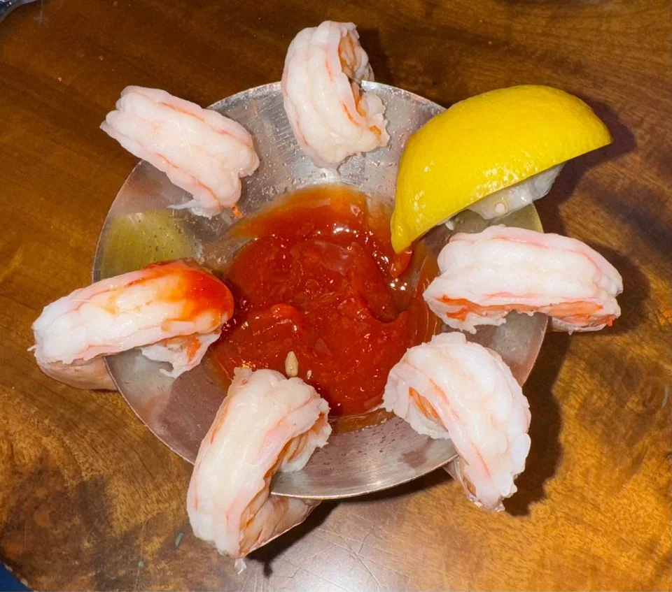 Classic shrimp cocktail served with cocktail sauce and lemon wedge