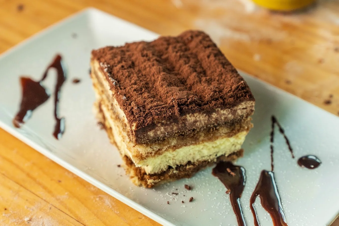 Classic Italian tiramisu dessert on a white plate