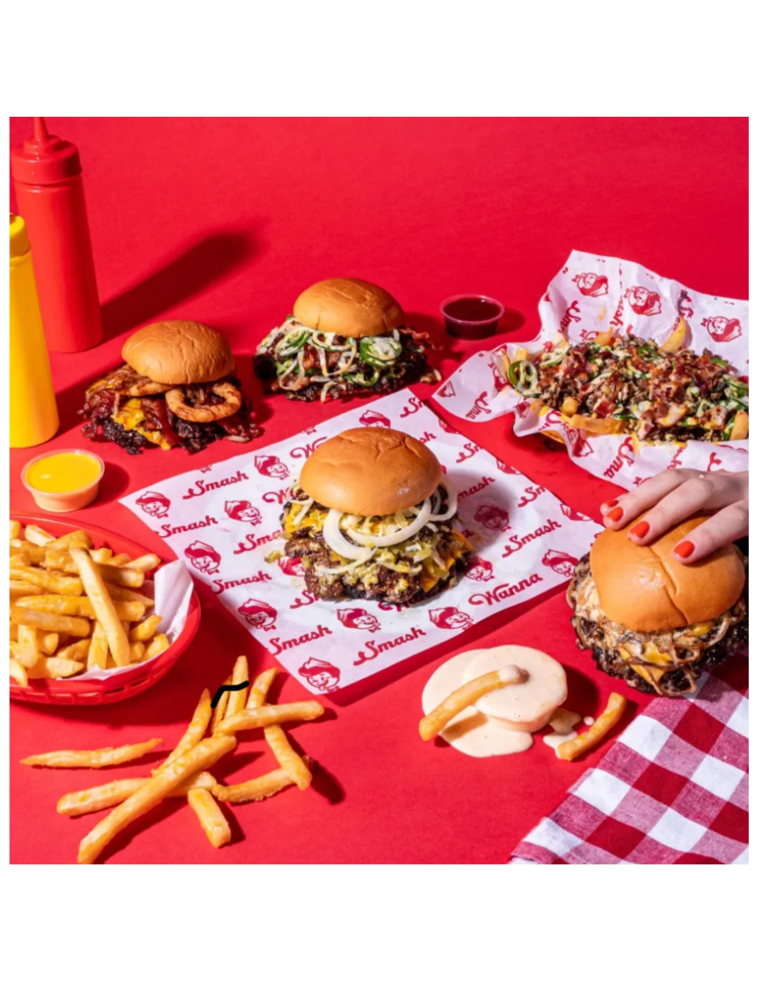 Gourmet burgers and fries on a vibrant red background