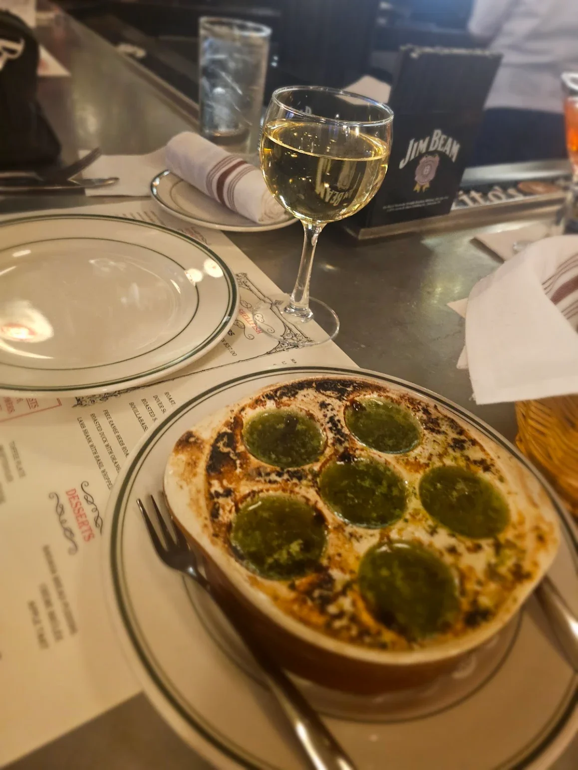 Baked escargot with garlic herb butter in a restaurant setting