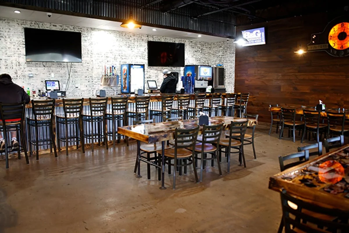 Cozy restaurant interior with bar seating and rustic decor