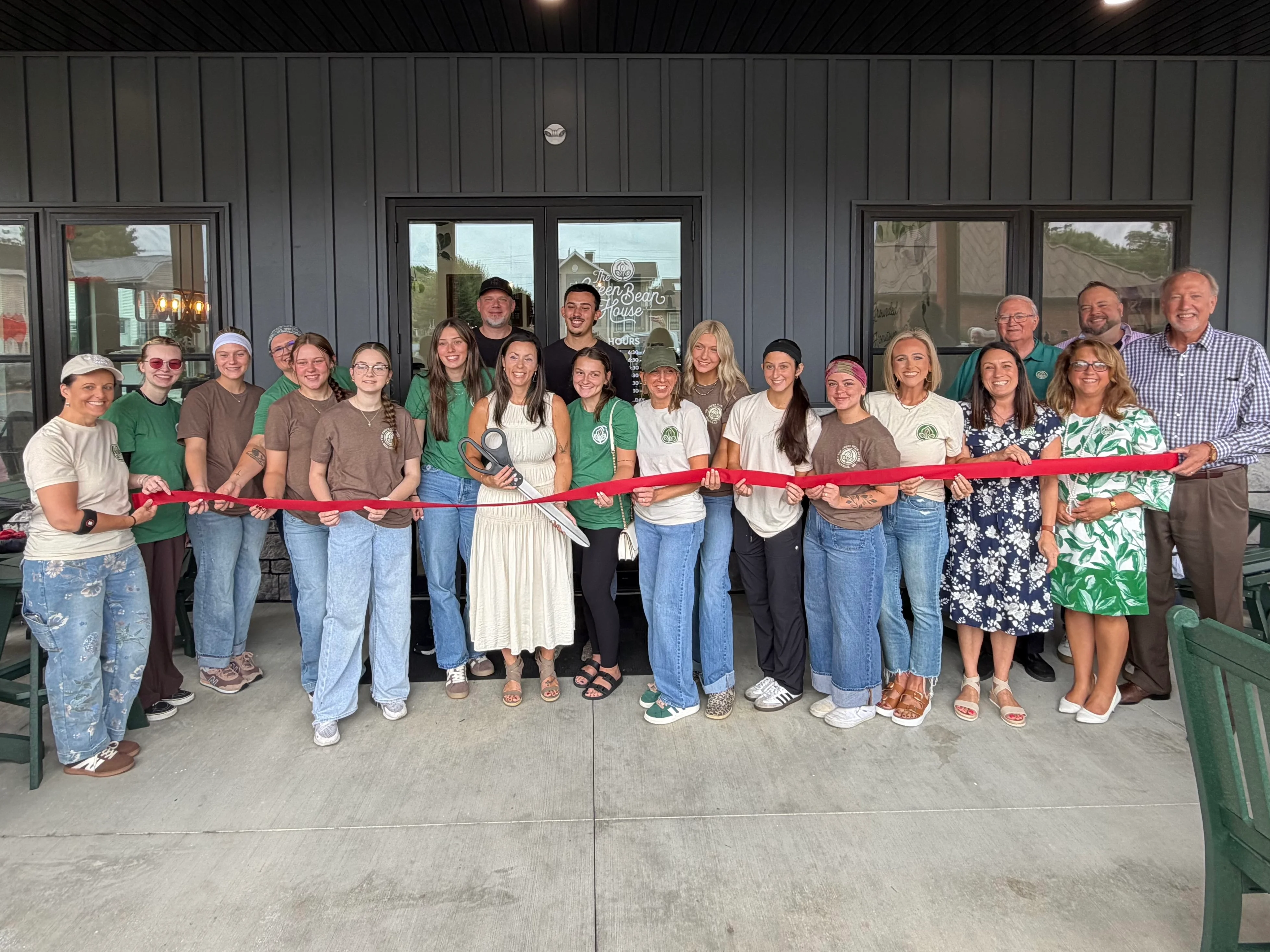 Ribbon-cutting ceremony for a new restaurant with staff and community members